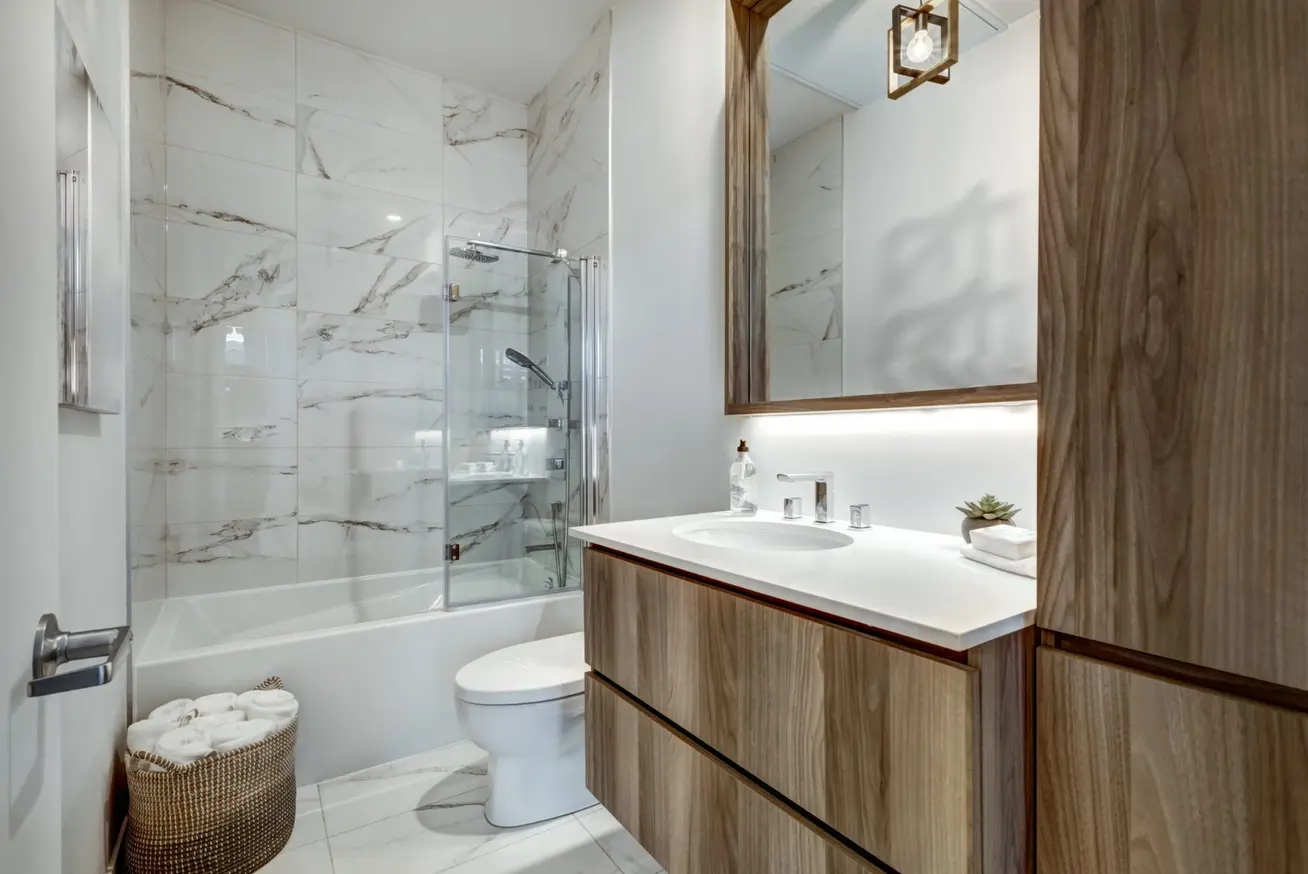 Wet room installation in Cardiff with timber vanity and black framed screen